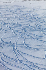 traces of the skis on the snow, traces of snowboarding on the snow-covered slope