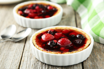 Fresh berry tarts on grey wooden background