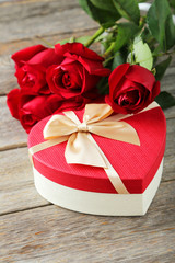 Beautiful heart gift box on grey wooden background