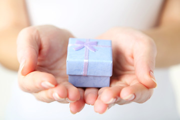 Female hands holding gift box