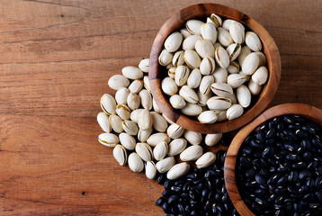 Nuts and dried fruits on vintage wooden boards still life