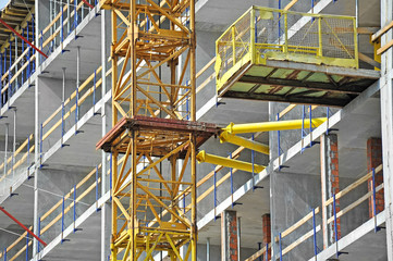 Fototapeta premium Crane and building construction site with balcony
