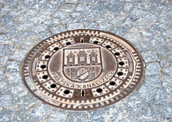 Prazska Kanalizace Manhole cover in the road, Prague.