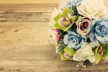 Artificial flowers on wooden background, Vintage effect