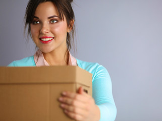 Portrait of pretty woman holding a box