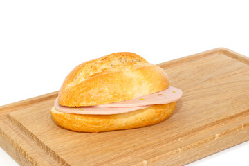 German bread roll with mortadella on breakfast tray