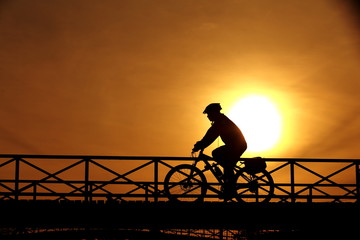 Fototapeta premium silhouette of a cyclist at sunset