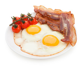 Plate with fried eggs, bacon isolated