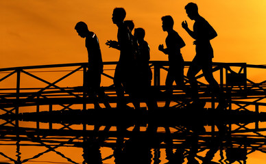 Obraz premium Silhouette of running girl at sunrise.