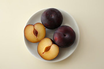 Half plum on white plate