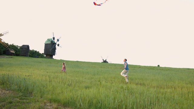 Father with child to fly a kite at sunset.
