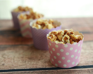caramel popcorn in pink and purple cupcake cups