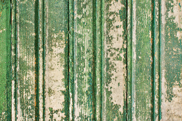 Wooden desks covered with green peeling paint texture 