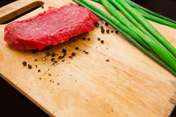 raw steak with pepper and onion