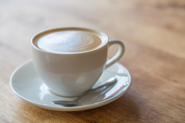 Coffee in white cup on wood table