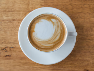 Coffee in white cup on wood table