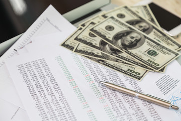 Financial charts on the table with laptop