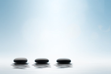 Fototapeta na wymiar Zen concept. Black spa stones on blue background.