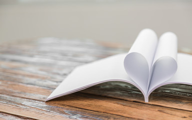 Book with opened pages of shape of heart