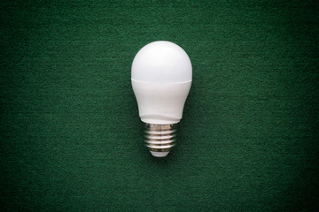 LED light bulb on a green background