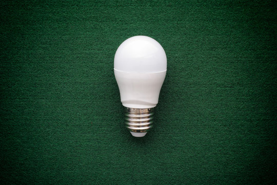 LED Light Bulb On A Green Background