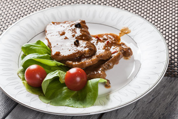 Pork chop with sauce and vegetables