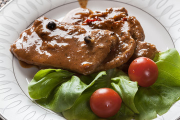 Pork chop with sauce and vegetables