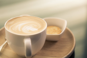Hot latte art coffee on table ( Filtered image processed vintage