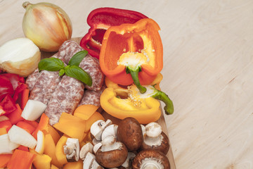 Sausage and sliced fresh vegetables.
