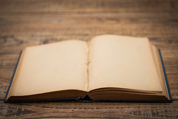 Open blank pages of old book on wood background