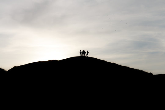 silhouettes of tourists on mountains