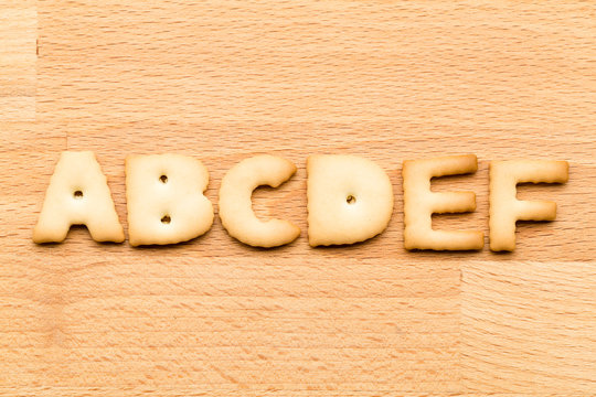 Letter ABCDEF cookie over the wooden background
