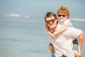 Hipster father with beard and red haired son wearing sunglasses