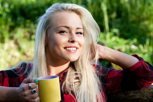 smiling blonde woman in the countryside