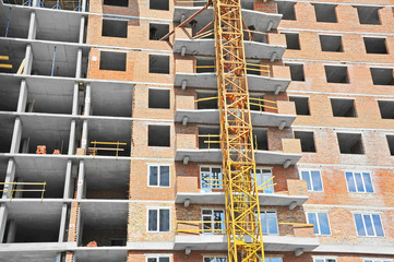 Crane and building construction site with balcony