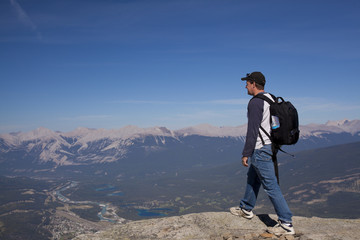 hiker looking over the top of the mountain