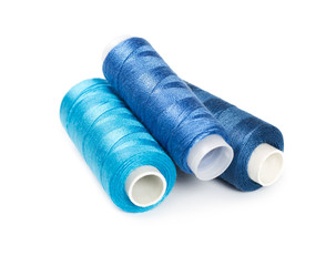 Three bobbins of thread blue color