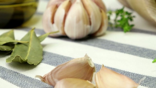 Bunches of rosemary and thyme with old-fashioned scissors. Wood table background.