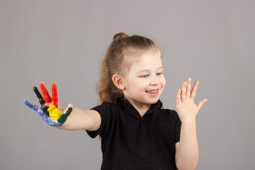 Little girl shows the hands painted