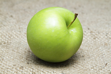 Green apple on sack.