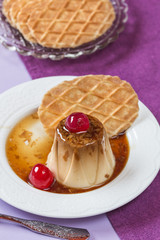 Panna cotta with cheries, caramel and wafer