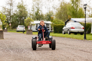 Boy driving on buggy cart