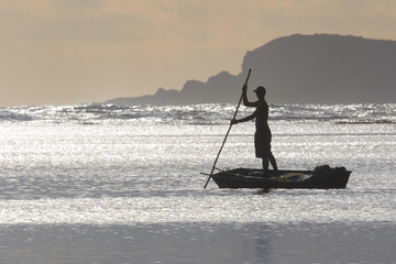 Silhouette of Fisherman Poling Boat at Sunrise, Kauai