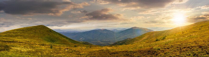 Naklejka na ściany i meble panorama of hillside with stones in high mountains at sunset