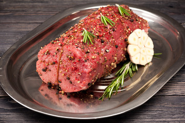 Roast beef on a wooden background