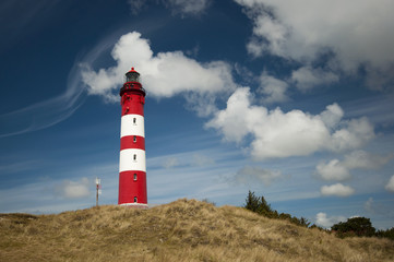 Lighthouse and dunes against beautiful sky at the German North Sea island Amrum, Germany, Europe