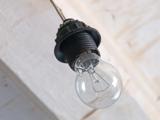 Incandescence lamp on a white ceiling background.