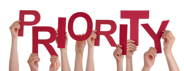 Many People Hands Holding Red Word Priority