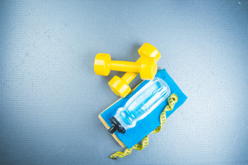 sneakers and a jump rope on a gray background.  Different tools for sport
