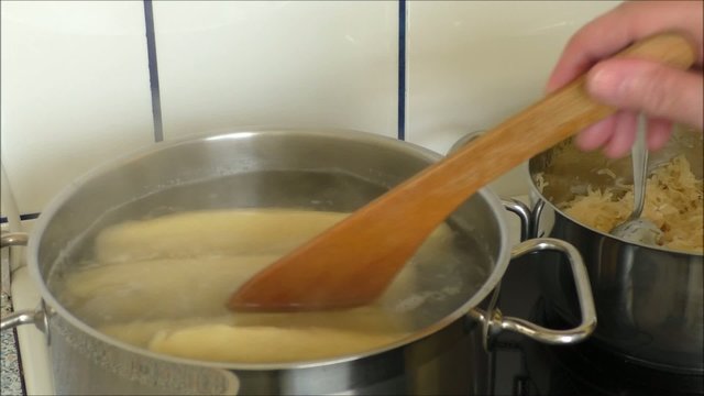 Close up of dumplings boiling in water
